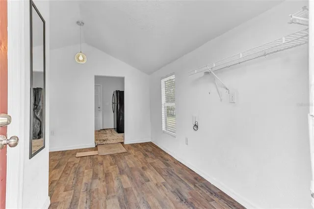 a view of a room with wooden floor and a window