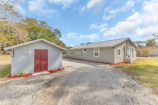 a view of garage and wooden fence