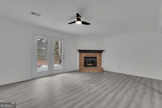 wooden floor fireplace and natural light in room