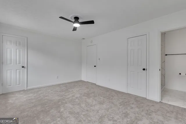 a view of a room with a ceiling fan