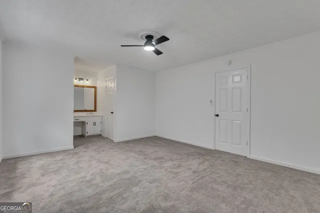 a view of an empty room with a ceiling fan