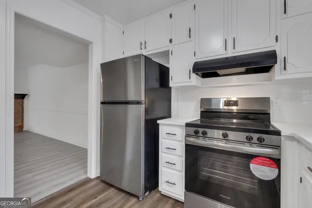 a kitchen with stainless steel appliances a refrigerator and a stove