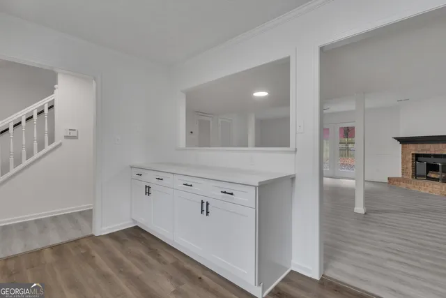 wooden floor with white cabinets and wooden floor