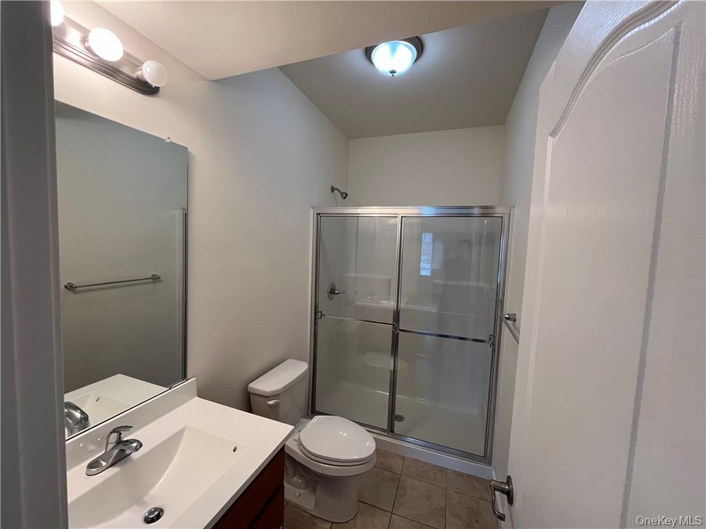 44 High Street, Unit 325 Chester, NY 10918 - Photo 11 of 16 a bathroom with a sink toilet and shower
