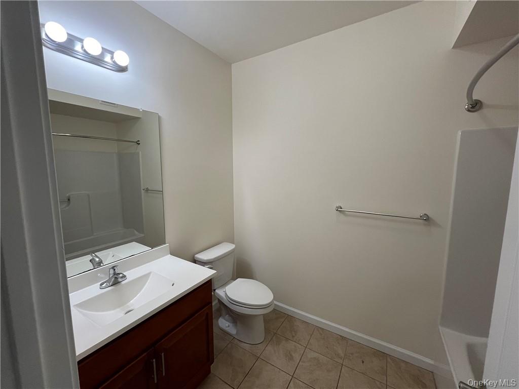 44 High Street, Unit 325 Chester, NY 10918 - Photo 10 of 16 a bathroom with a sink toilet and a mirror