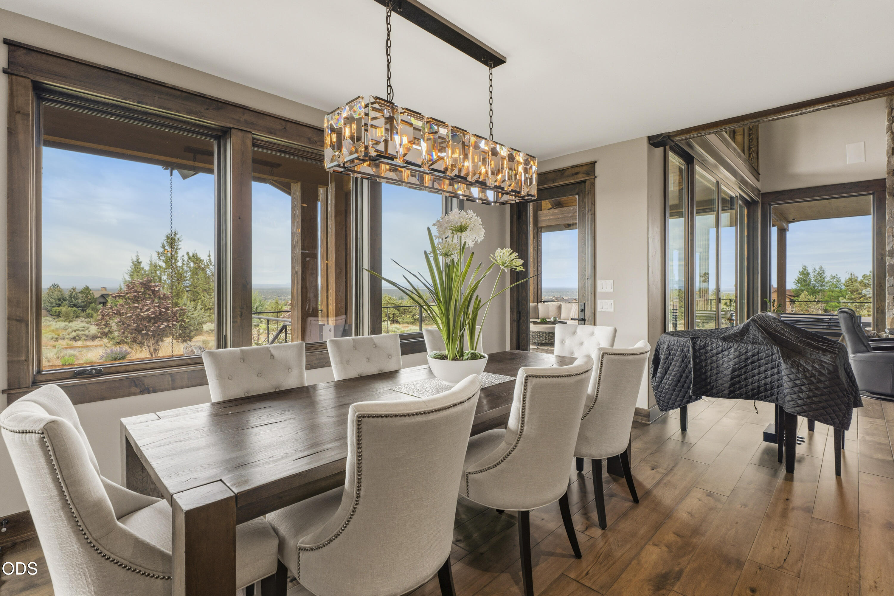 15935 South W Brasada Ranch Road Powell Butte, OR 97753 - Photo 6 of 45 a view of a dining room with furniture wooden floor and chandelier