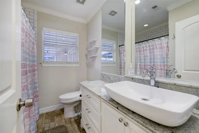 a bathroom with a sink toilet and shower