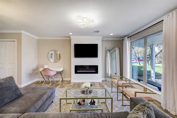 a living room with furniture a flat screen tv and a fireplace
