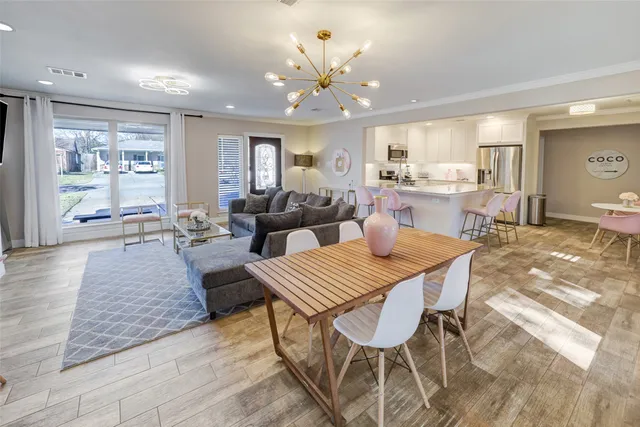 a living room with fireplace furniture and a wooden floor