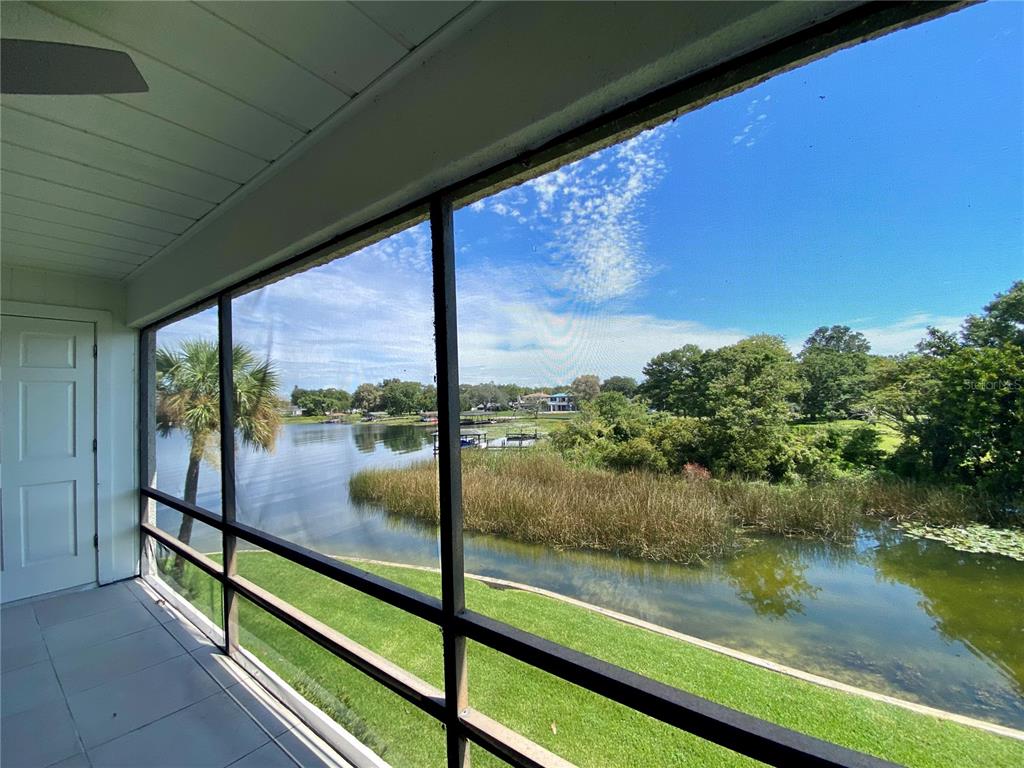 Stunning view of Lake Fairview and canal from your private screened rear porch/balcony! Peaceful