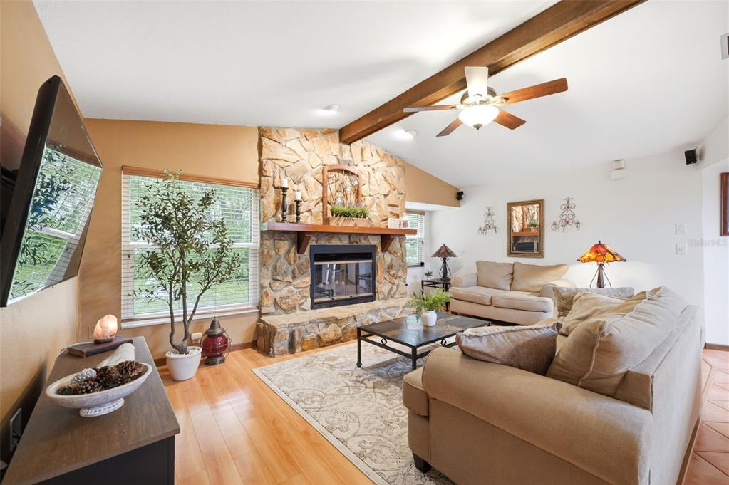 5227 Suwannee Road Weeki Wachee, FL 34607 - Photo 14 of 62 a living room with furniture fireplace and a large window