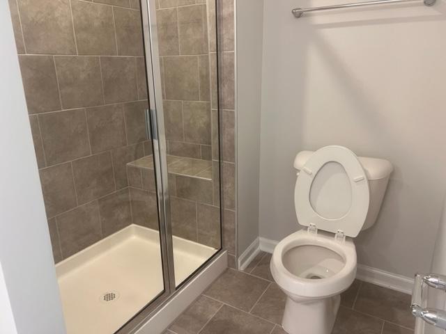 217 Ivy Vine Way Raleigh, NC 27610 - Photo 13 of 18 a bathroom with a sink a toilet and shower