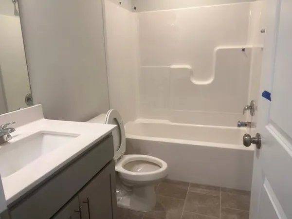 a bathroom with a sink a toilet and a bathtub