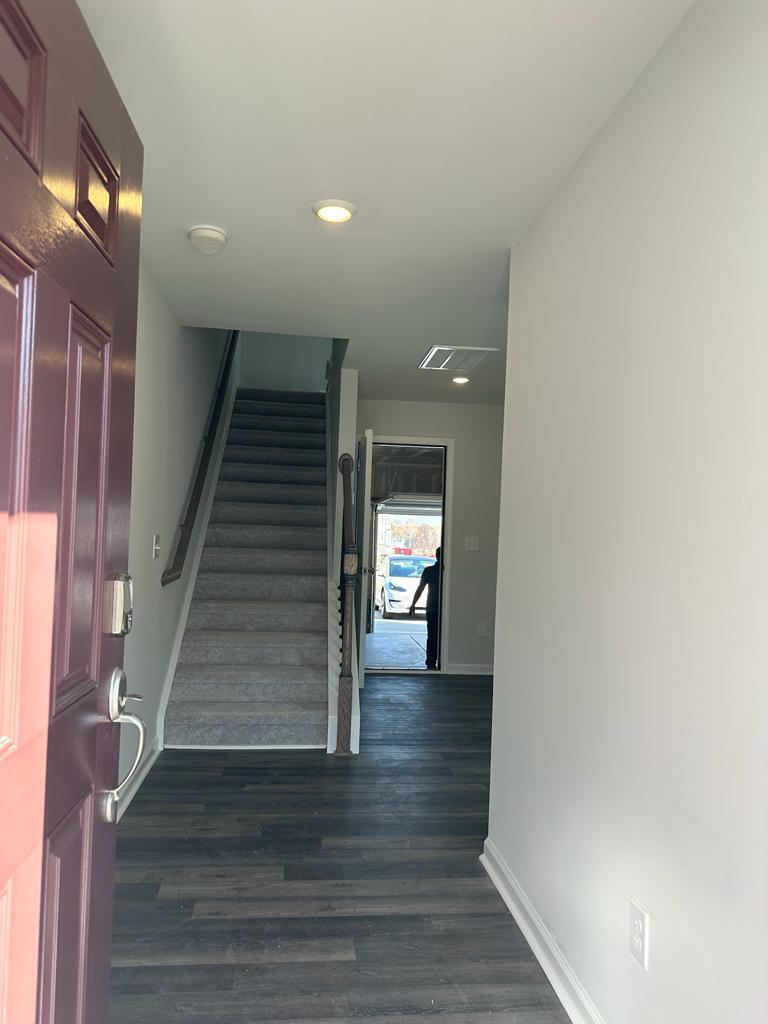 217 Ivy Vine Way Raleigh, NC 27610 - Photo 3 of 18 a view of a hallway with wooden floor and staircase