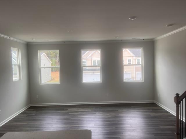 217 Ivy Vine Way Raleigh, NC 27610 - Photo 8 of 18 an empty room with wooden floor and windows
