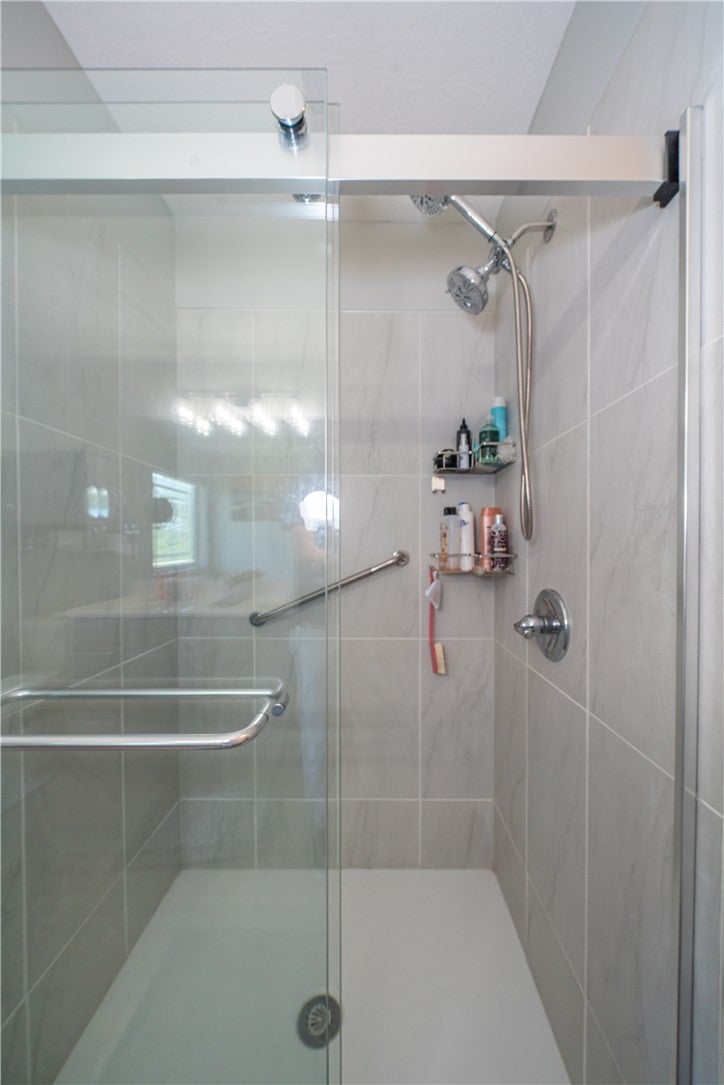 10765 Stone Ridge Way Harrison, OH 45030 - Photo 27 of 68 A sleek, tiled shower with glass enclosure offers a contemporary bathing experience.