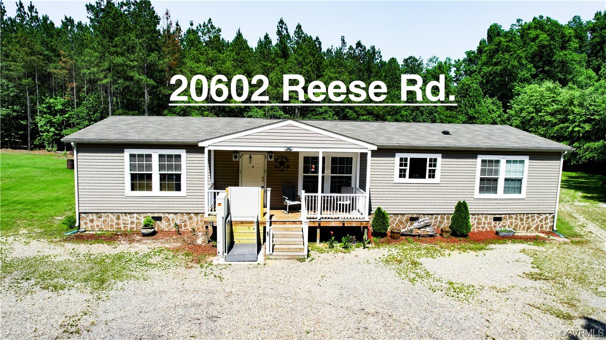 20602 Reese Road Dinwiddie, VA 23841 - Photo 1 of 50 a front view of a house with a yard table and chairs
