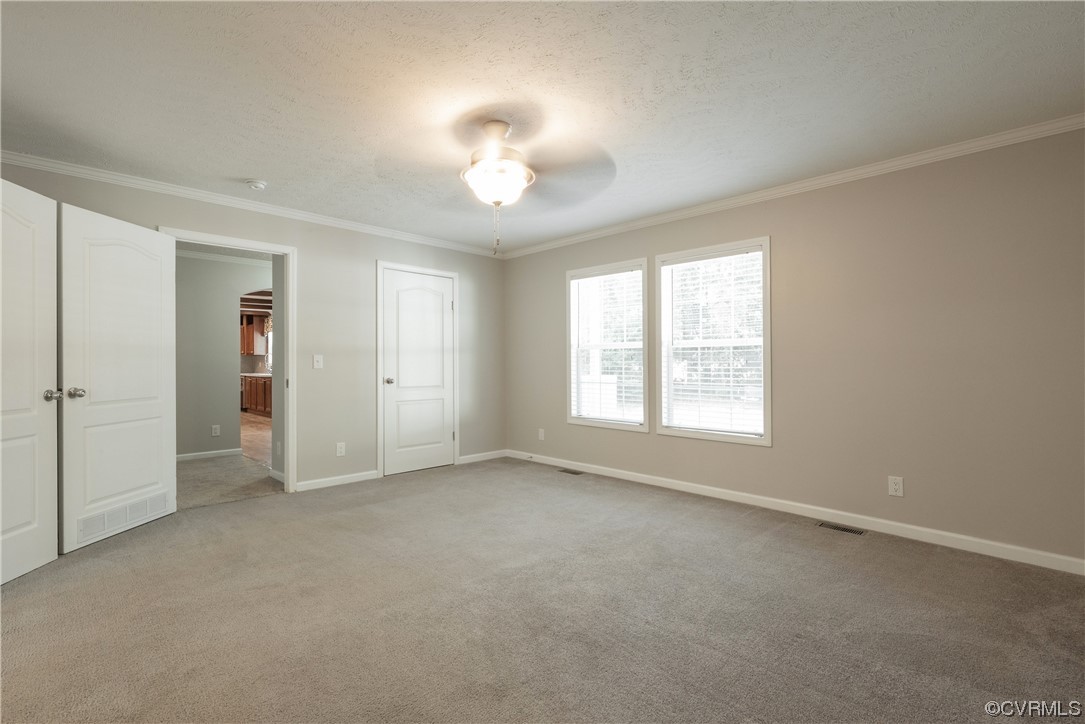 20602 Reese Road Dinwiddie, VA 23841 - Photo 14 of 50 an empty room with windows and chandelier fan