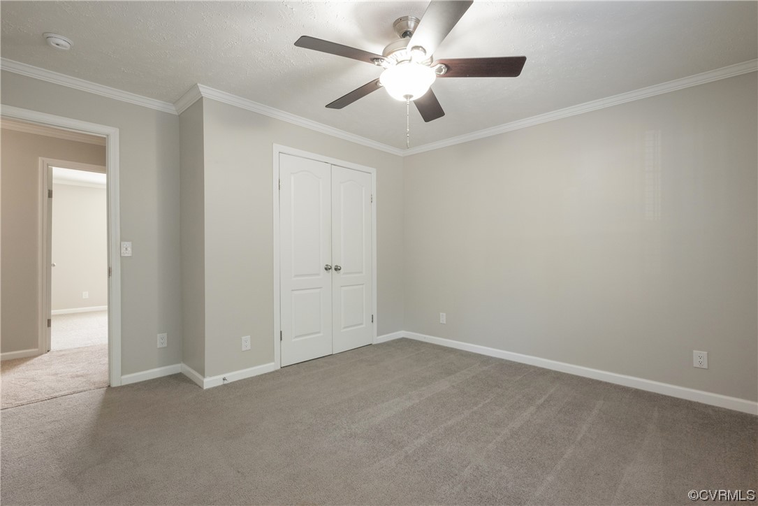 20602 Reese Road Dinwiddie, VA 23841 - Photo 21 of 50 an empty room with a chandelier fan and windows