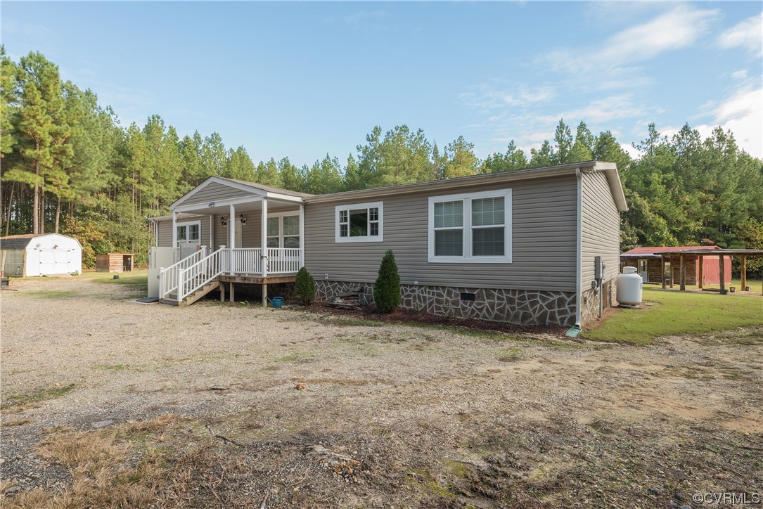 20602 Reese Road Dinwiddie, VA 23841 - Photo 34 of 50 a view of a house with a yard and potted plants
