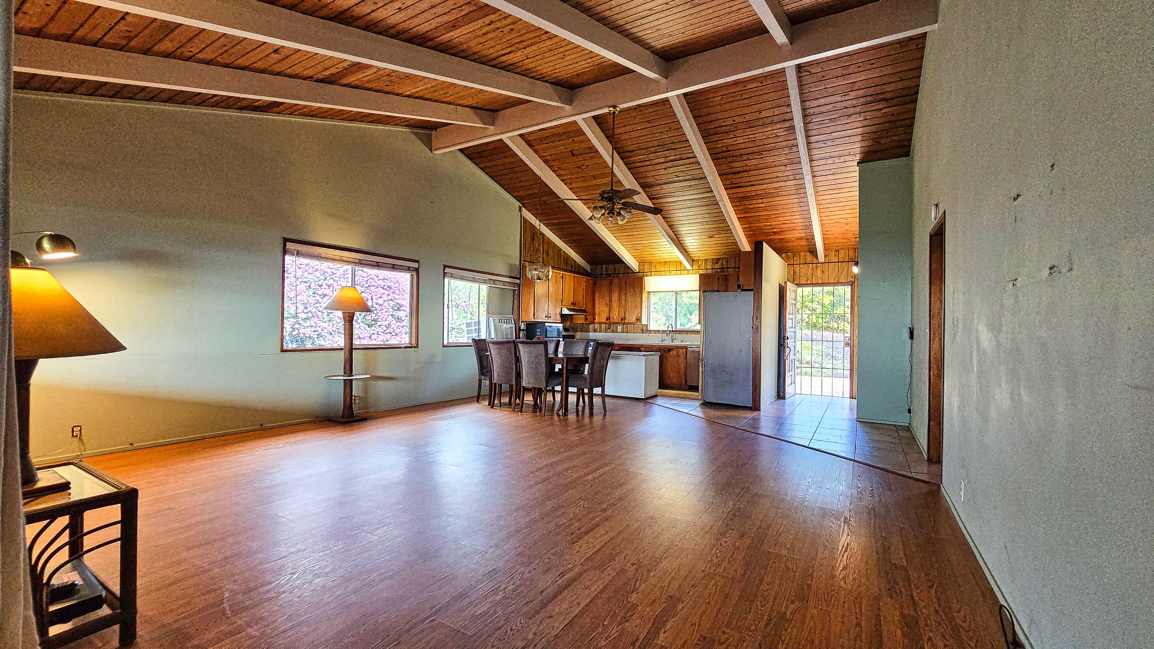 92-8233 Reef Parkway Ocean View, HI 96704 - Photo 9 of 30 a view of an empty room with wooden floor and a window