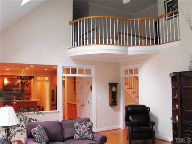 2124 Tibwin Drive Raleigh, NC 27606 - Photo 3 of 6 View of the kitchen and breakfast area from the family room. Note the Juliet balcony on the second floor hall!!