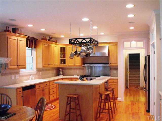 2124 Tibwin Drive Raleigh, NC 27606 - Photo 5 of 6 This is truly a chef's kitchen with an island prep area sink. The Viking stove has 4 burners, a grill & griddle, a gas oven & a convection oven.