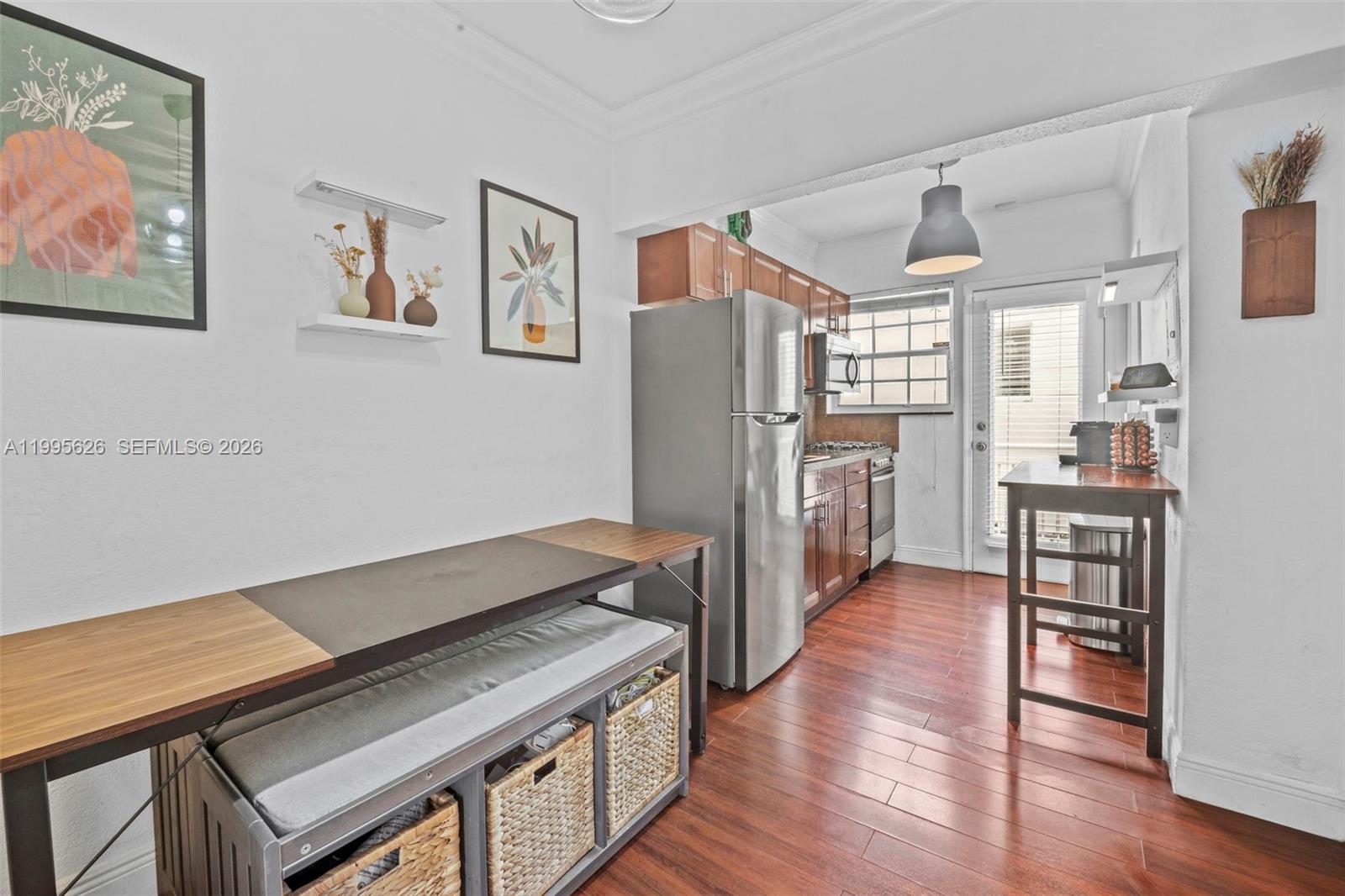330 74th Street, Unit 5 Miami Beach, FL 33141 - Photo 6 of 19 a kitchen with stainless steel appliances granite countertop a refrigerator and a stove top oven