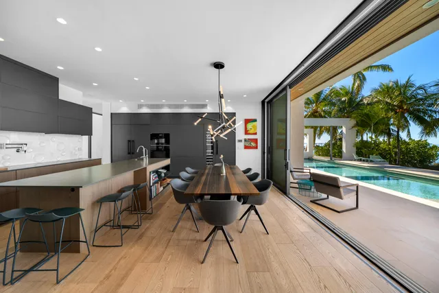 a view of a swimming pool with a yard and palm trees