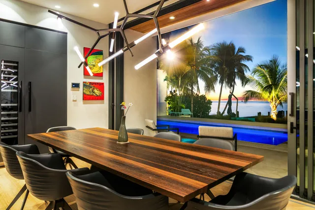 a view of a swimming pool with a table and chairs under an umbrella