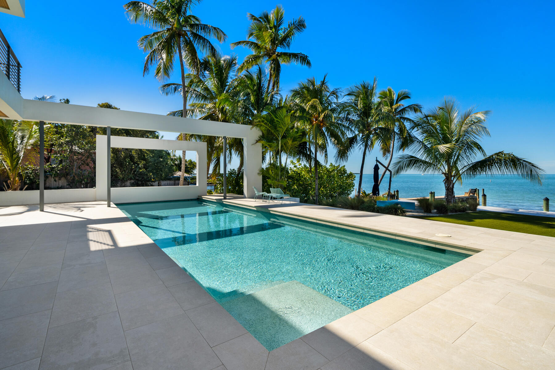 19 Avacado Street Islamorada, FL 33036 - Photo 22 of 104 a view of a swimming pool with a yard and palm trees