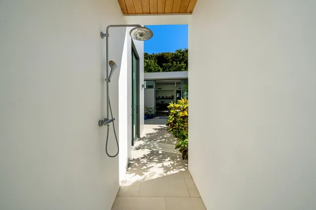 a living room with furniture floor to ceiling window and a floor to ceiling window