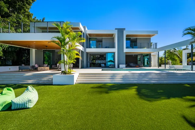 a bedroom with a bed a large window with the outer view