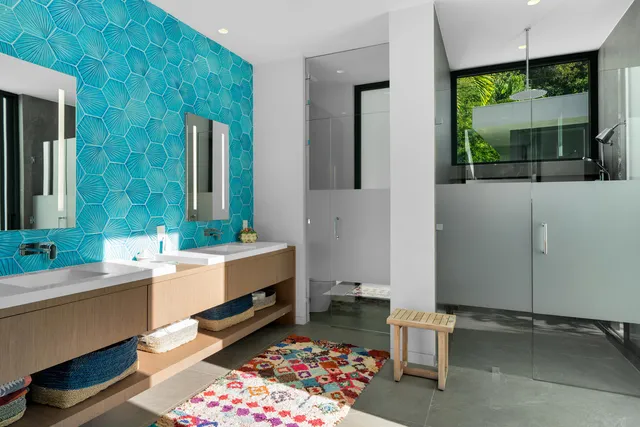 a view of a backyard with potted plants and large trees