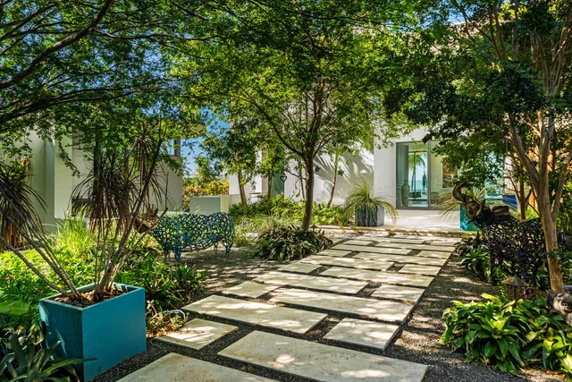 a room with stainless steel appliances kitchen island a table and chairs in it