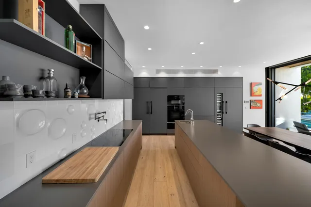 a view of a patio with couches chairs potted plants and floor to ceiling window
