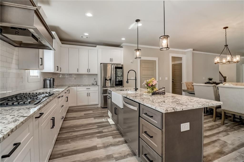 569 White Oak Way Monroe, GA 30655 - Photo 13 of 50 a kitchen with a sink stove and cabinets