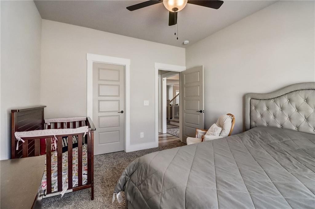 569 White Oak Way Monroe, GA 30655 - Photo 16 of 50 a bedroom with a bed and a desk