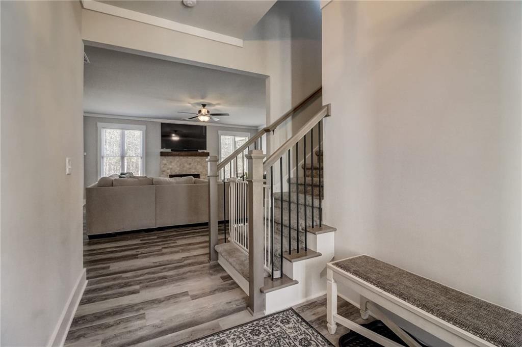 569 White Oak Way Monroe, GA 30655 - Photo 18 of 50 a view of a livingroom with wooden floor and stairs
