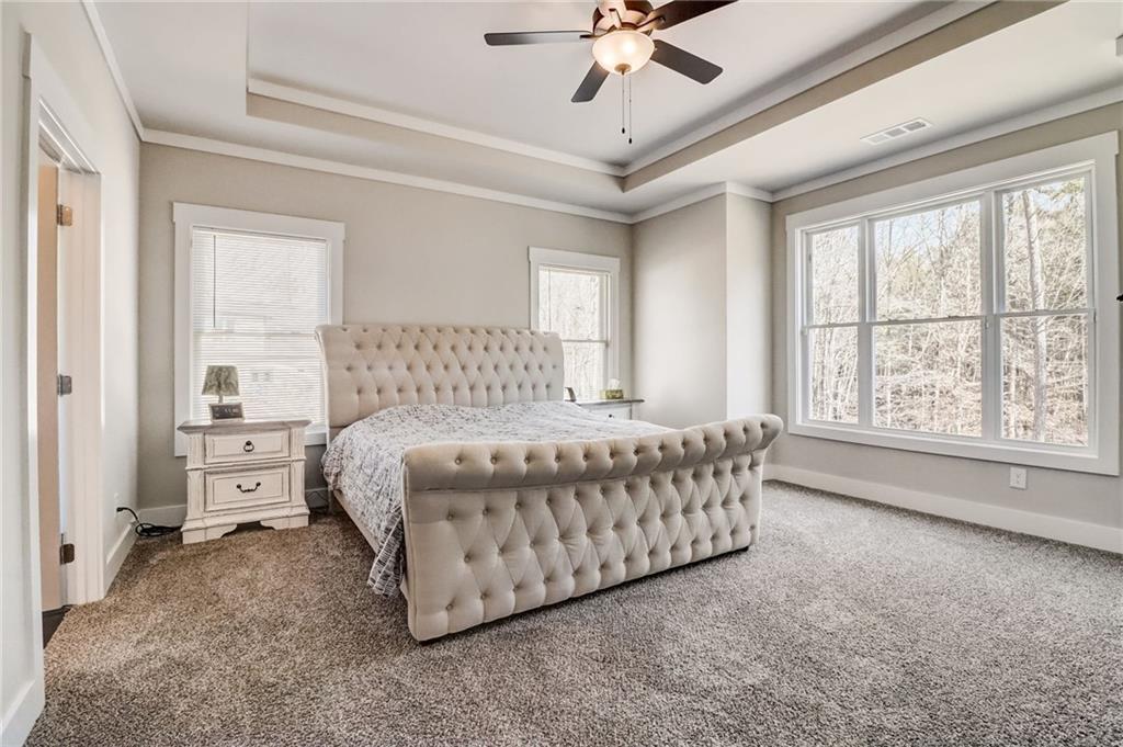 569 White Oak Way Monroe, GA 30655 - Photo 19 of 50 a spacious bedroom with a bed and window