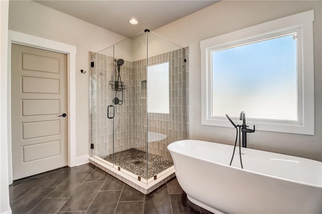 569 White Oak Way Monroe, GA 30655 - Photo 21 of 50 a white bath tub sitting next to a bathroom
