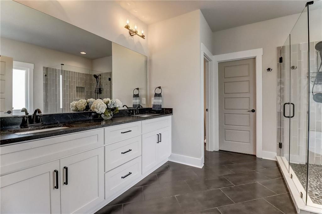 569 White Oak Way Monroe, GA 30655 - Photo 22 of 50 a bathroom with a double vanity sink and mirror