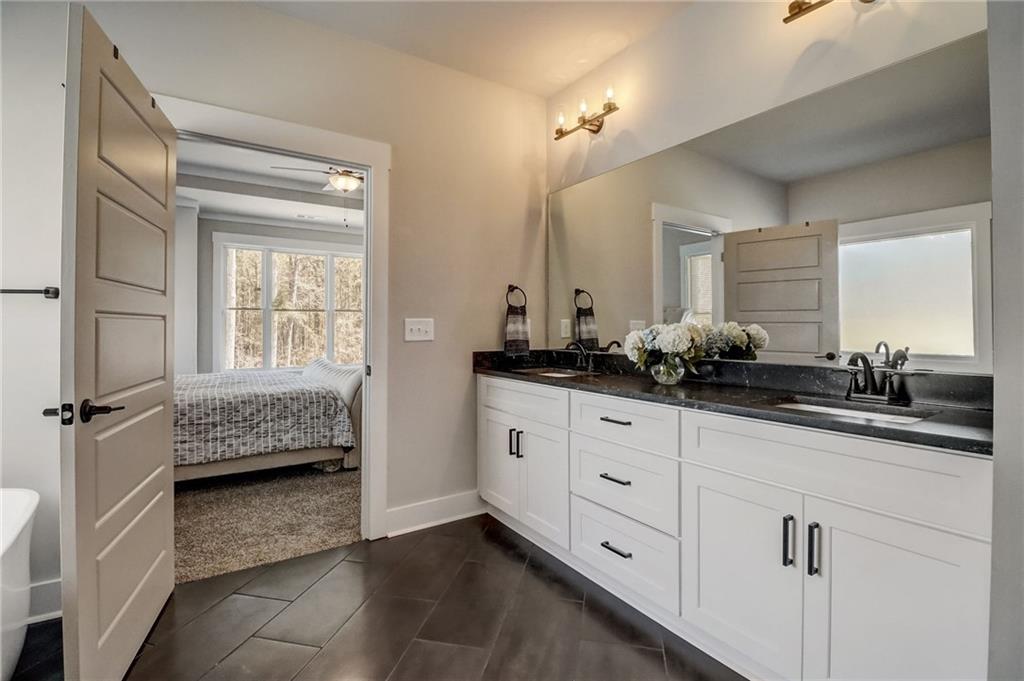 569 White Oak Way Monroe, GA 30655 - Photo 23 of 50 a en suite bathroom with a double vanity sink and a window