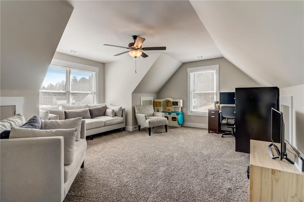 569 White Oak Way Monroe, GA 30655 - Photo 29 of 50 a living room with furniture and a flat screen tv
