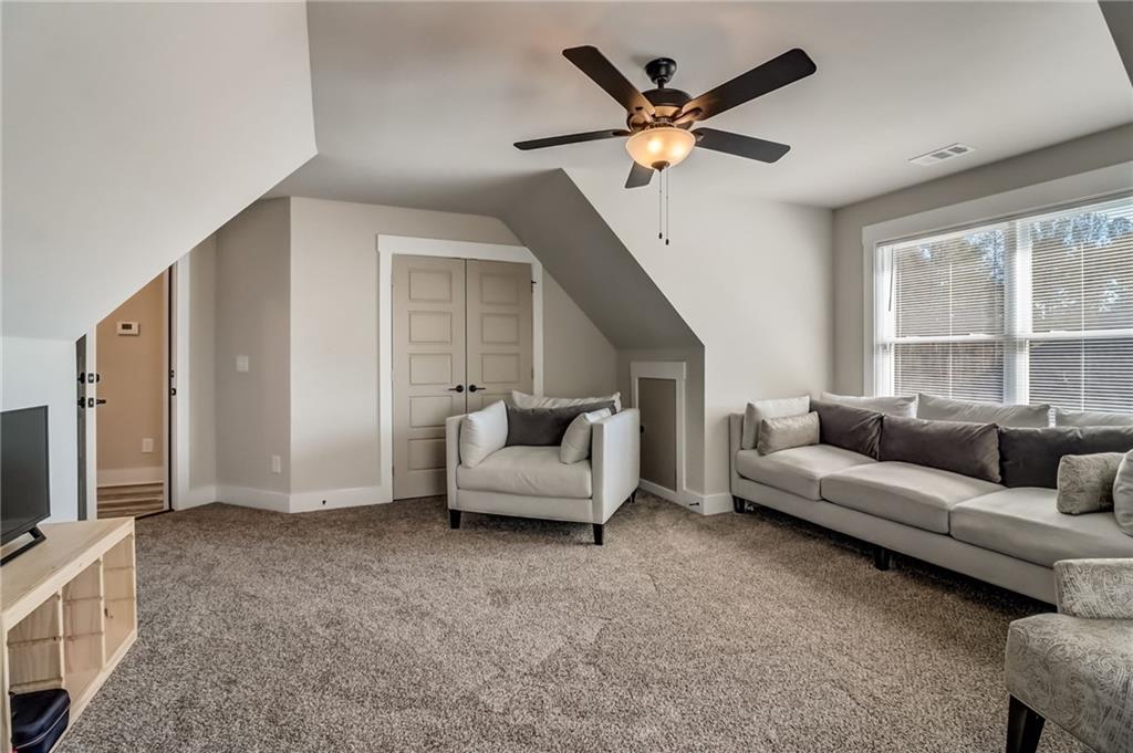 569 White Oak Way Monroe, GA 30655 - Photo 30 of 50 a living room with furniture and a flat screen tv