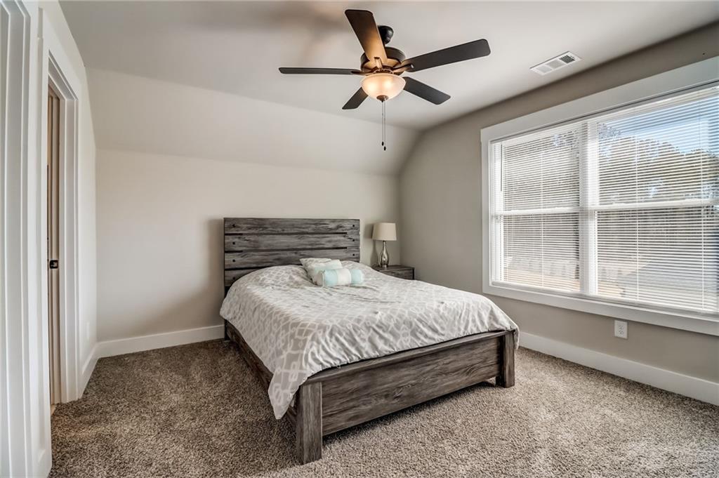 569 White Oak Way Monroe, GA 30655 - Photo 31 of 50 a bed sitting in a bedroom next to a window