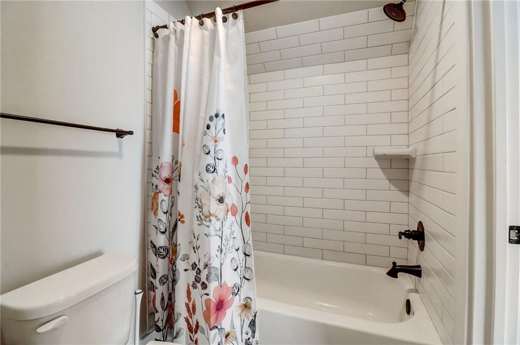 569 White Oak Way Monroe, GA 30655 - Photo 33 of 50 a bathroom with a bathtub and shower