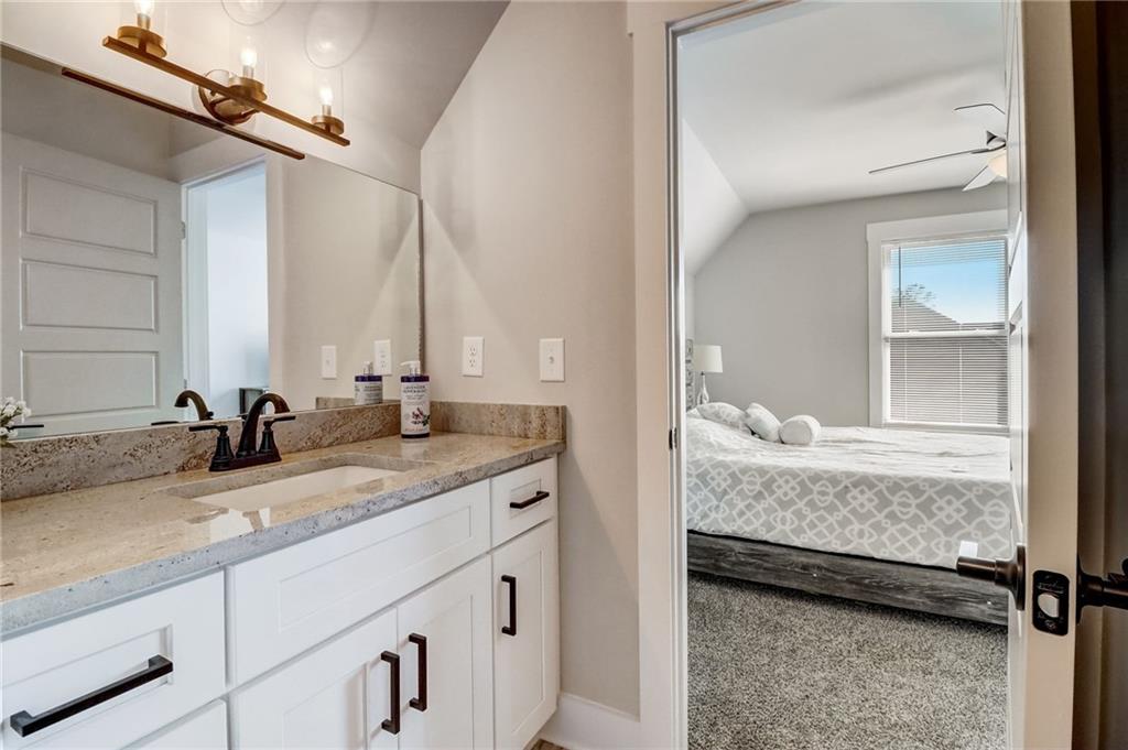 569 White Oak Way Monroe, GA 30655 - Photo 35 of 50 a bathroom with a granite countertop sink and a mirror