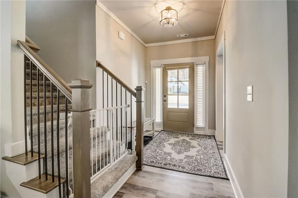 569 White Oak Way Monroe, GA 30655 - Photo 5 of 50 a view of entryway with wooden floor and stairs