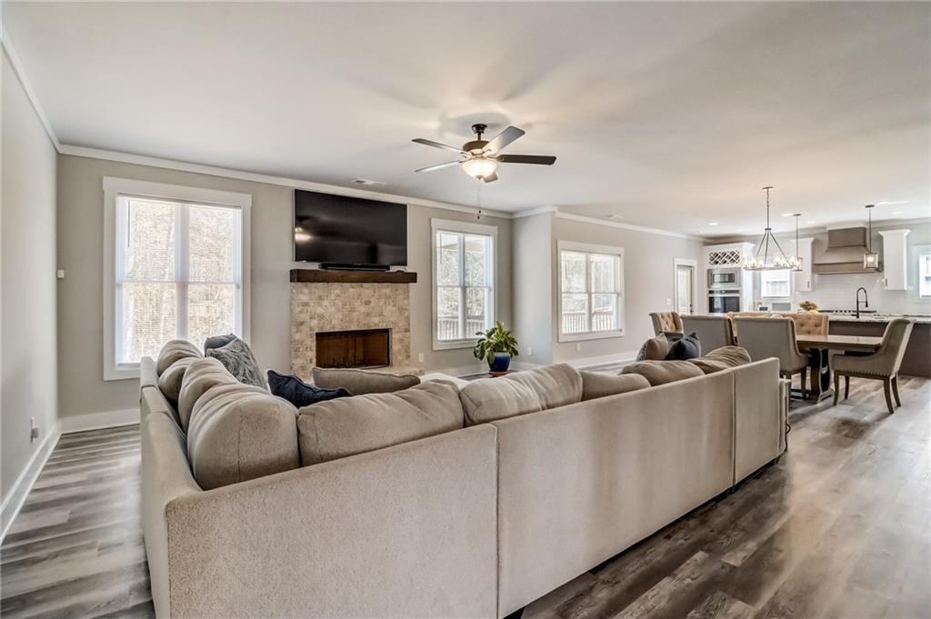 569 White Oak Way Monroe, GA 30655 - Photo 7 of 50 a living room with furniture a flat screen tv and a fireplace